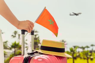 Traveller with Moroccan flag and suitcase