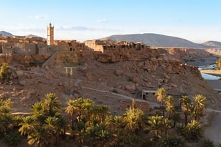 Rocky Moroccan village overlooking lush palm oasis