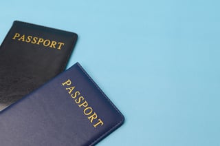 Two Passports On Blue Background