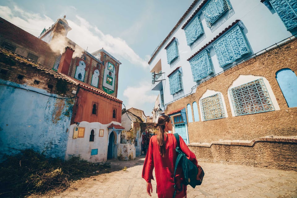A Tourist Walking Down A Street In Morocco